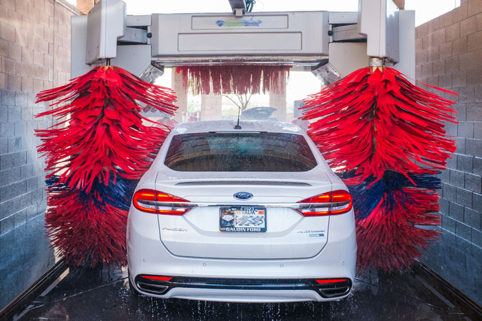 A white car in an automatic car wash.