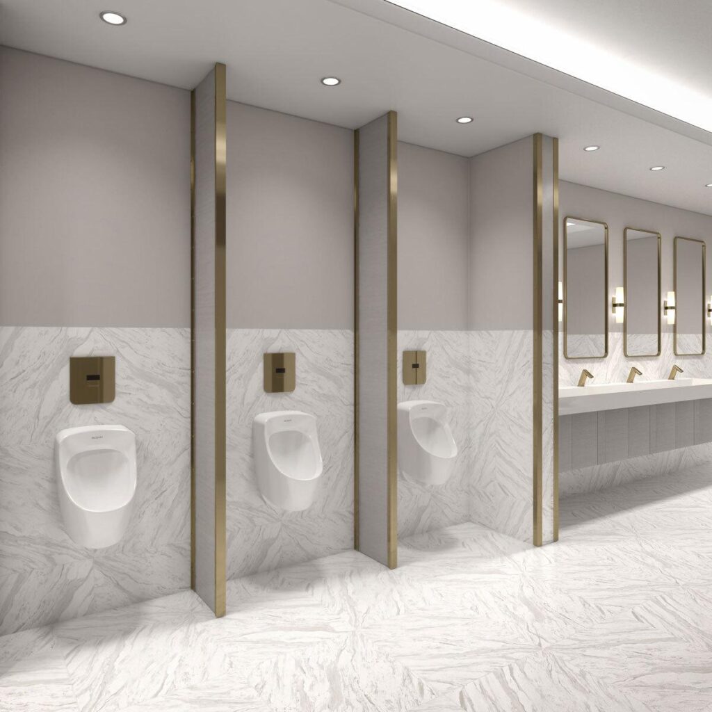 A white restroom with gold-trim featuring the Sloan CX Concealed Sensor Flushometer