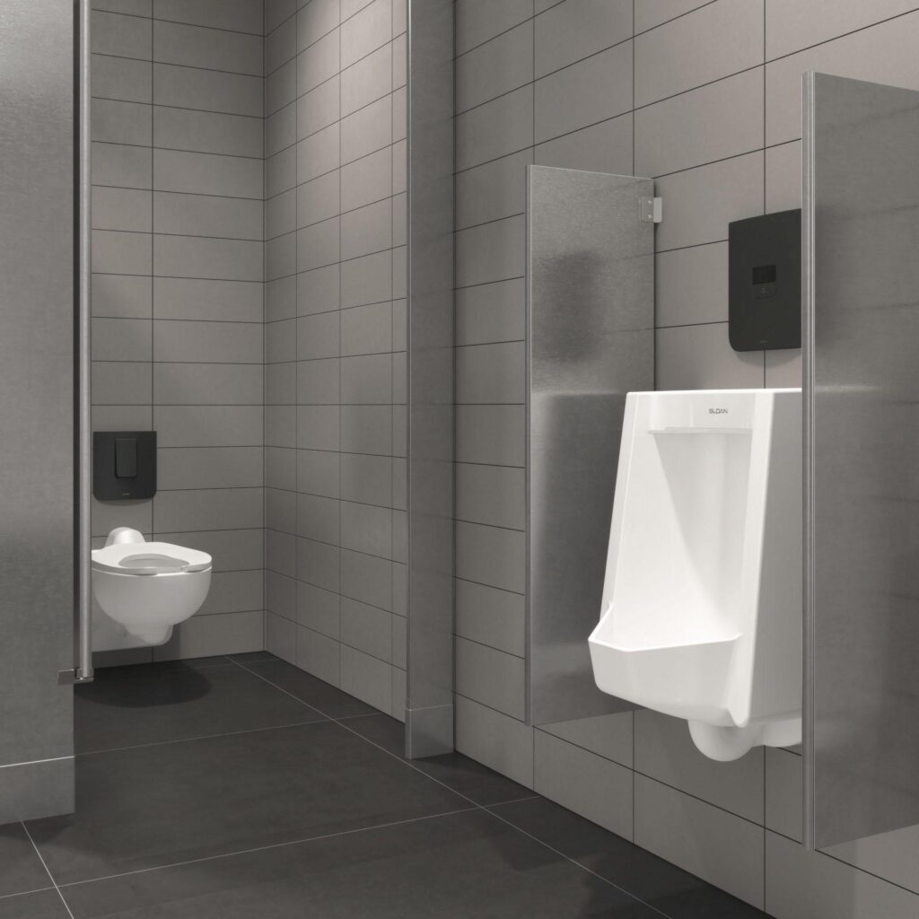 A stainless steel, modern bathroom with toilet and urinal featuring Sloan's CX Concealed sensor flushometers.